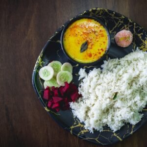 A black plate topped with different types of food